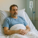 man in hospital bed